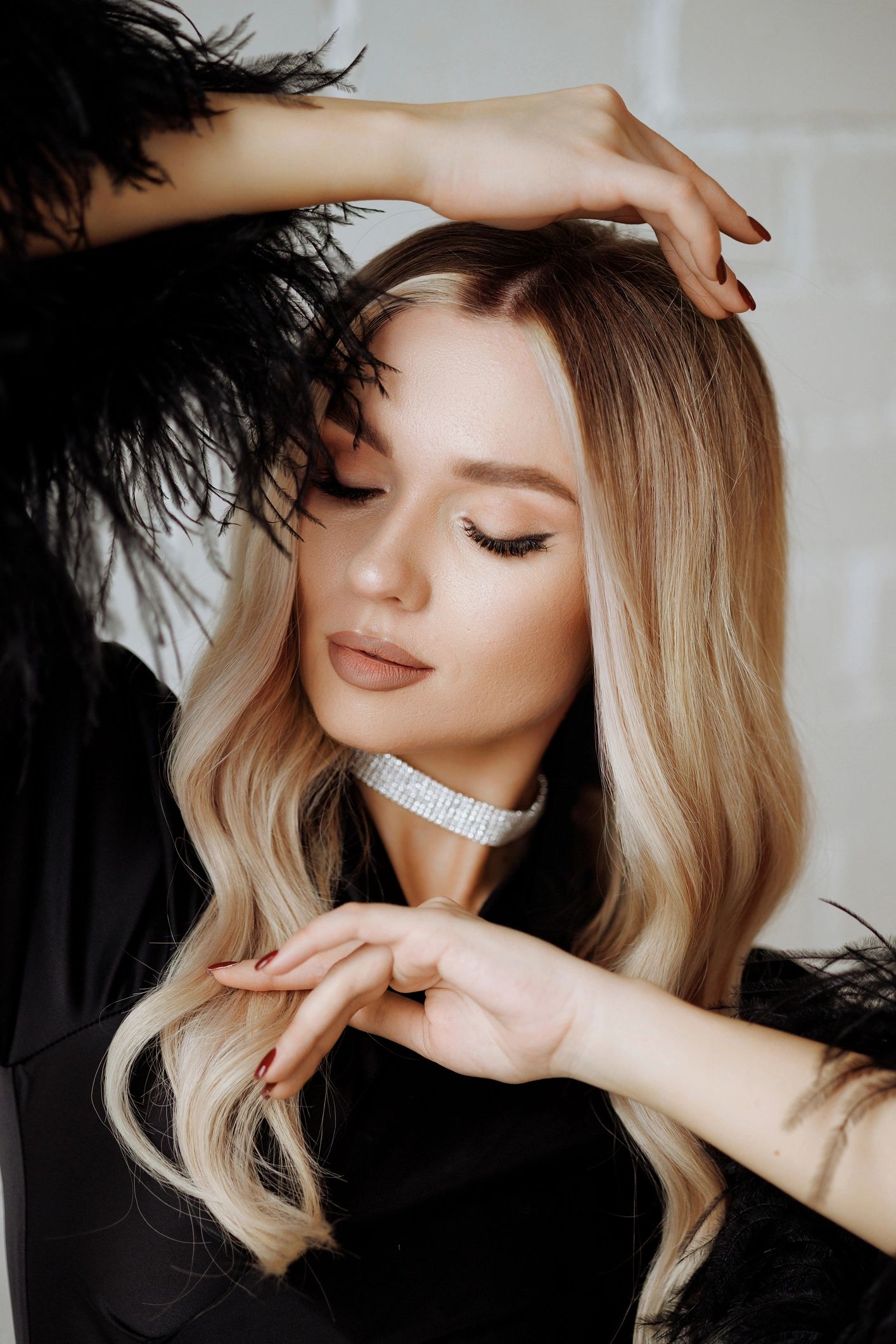 Woman with long blonde hair in black dress.